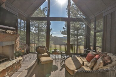 Inviting Screened Porch with Stone Fireplace & Ret