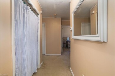 Hallway with washer/dryer on left.