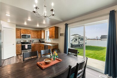 Dining space with a chandelier, wood-style floors, and recessed lighting