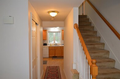 Bright and white main hallway leads to the kitchen