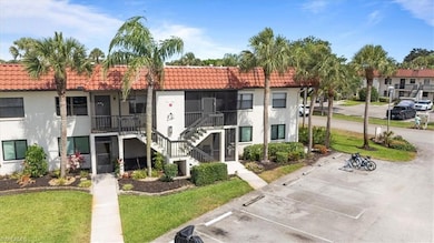View of property featuring uncovered parking and s