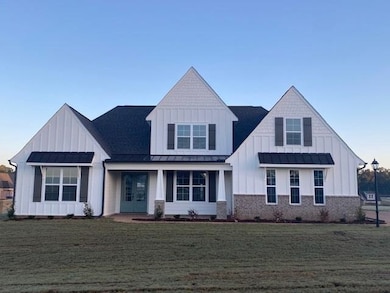 Modern inspired farmhouse featuring a front yard