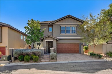 View of front facade with a garage, stucco siding, decorative driveway, and a gate