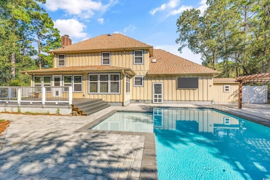 Exterior space with a pergola, a pool side deck, a