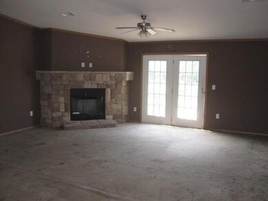 Unfurnished living room with a stone fireplace, ca