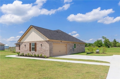 View of home's exterior featuring brick siding, bo