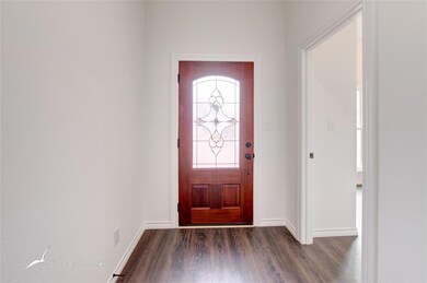 A beautiful entry way! First bedroom is showing on