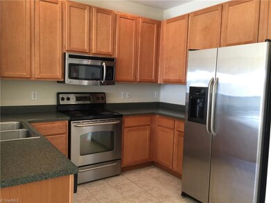 Kitchen with all stainless steel appliances, garbage disposal and tiled floor