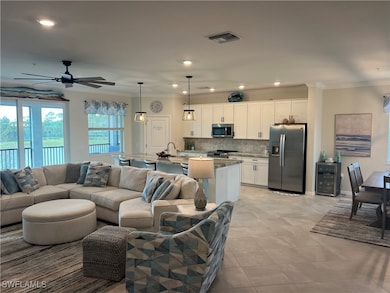 Tiled living room featuring ceiling fan, crown mol
