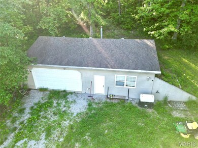View of front of home with driveway, a shingled roof, a front lawn, and a garage
