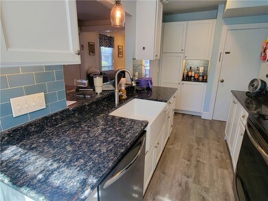 Modern galley kitchen with breakfast bar and stone countertops