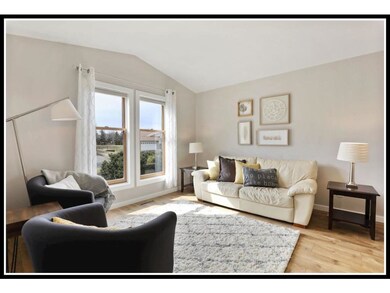 Large window and vaulted ceiling make the living r