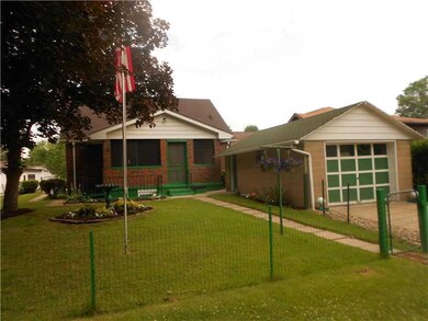 Exterior Back. MANICURED YARD WITH DETACHED GARAGE