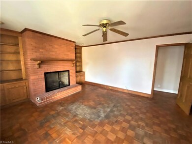 Den with built-ins and fireplace