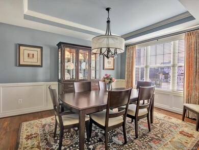 Dining Room with tray ceiling, crown moulding and beautiful hardwood floors which are throughout the first level.