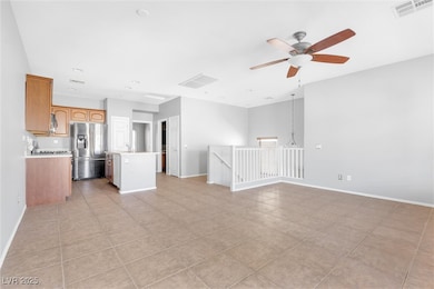 Unfurnished living room featuring light tile patte