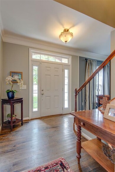 Foyer is light and bright with the transoms, woode