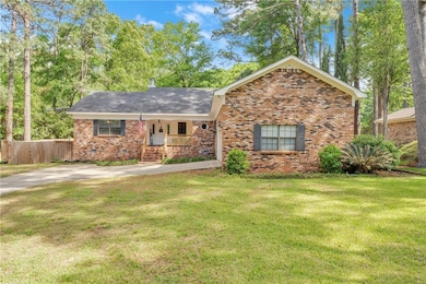 Ranch-style home with a front lawn, brick siding, 