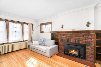 Living room with radiator heating unit, a brick fi