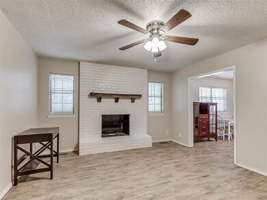 Living room featuring ceiling fan, light hardwood 