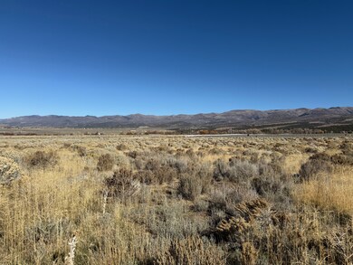 View of mountain backdrop with rural landscape