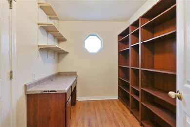 Office with built in desk and shelves.
