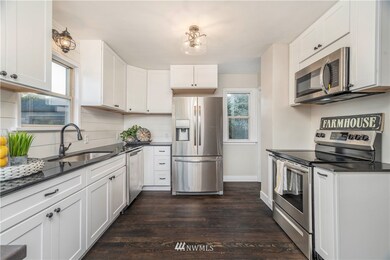 Tastefully updated kitchen with granite countertops, undermount sink, and brand new stainless steel appliances