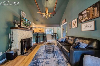 nice open living room with wood fireplace   beams 