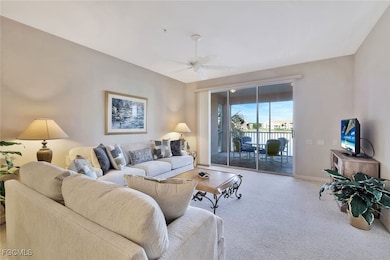 Living area featuring carpet floors and a ceiling fan