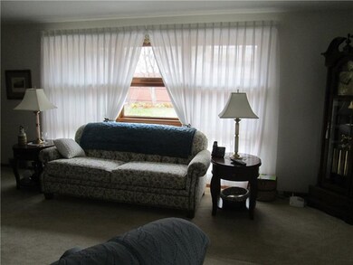Living Room window overlooks fenced in back yard