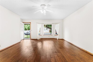 Living room with ceiling fan, dark hardwood / wood