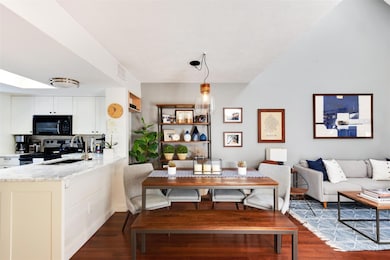 Living area featuring dark wood-style floors