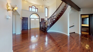 Two story foyer with chandelier and adjacent full