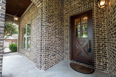 View of exterior entry with brick siding