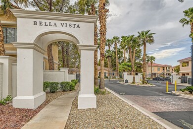 View of asphalt street with a gate, a gated entry,