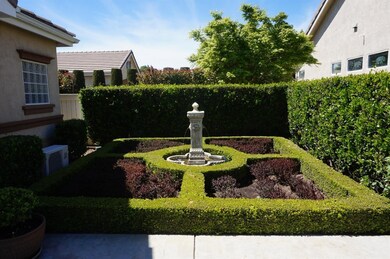 SCULPTED GARDEN WITH EUROPEAN STYLE FOUNTAIN.