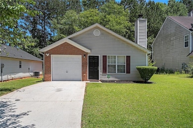 View of front of property featuring a front lawn, concrete driveway, brick siding, an attached garage, and cooling unit