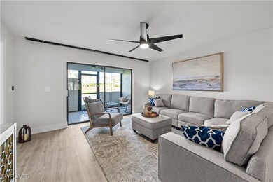 Living room with ceiling fan and light hardwood /