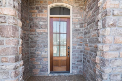 Entrance to property with brick siding and stone s