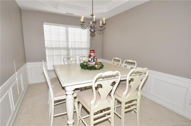 Dining room off of living room with wainscoting an