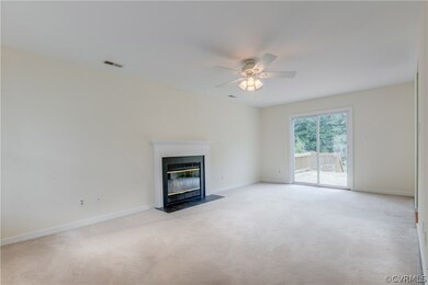 Living room with wood burning FP, sliding doors to