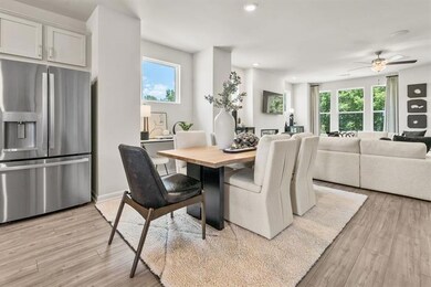 Dining area with healthy amount of natural light, light wood-style flooring, ceiling fan, and recessed lighting
