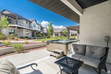 View of patio featuring an outdoor hangout area, a pergola, and a hot tub