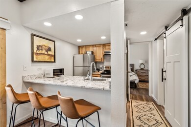Kitchen with dark hardwood / wood-style flooring,