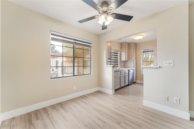 Spare room featuring light wood-style flooring and a ceiling fan