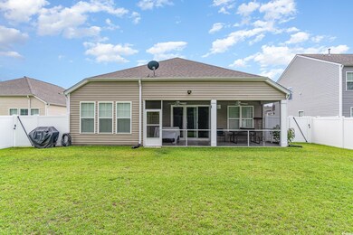 Back of property featuring a patio, a sunroom, cei