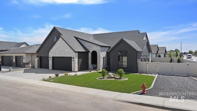 View of front of home featuring board and batten siding, a gate, a garage, and concrete driveway