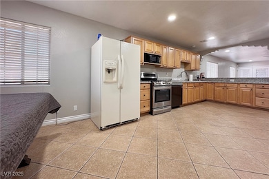 Kitchen with white fridge with ice dispenser, blac
