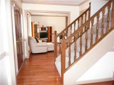 Light filled foyer has gleaming hardwood flooring 