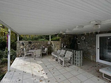 Patio/Deck. Lower patio with bar -- lots of room to entertain, with great view of lake.  Door on right leads to half bath / changing room.